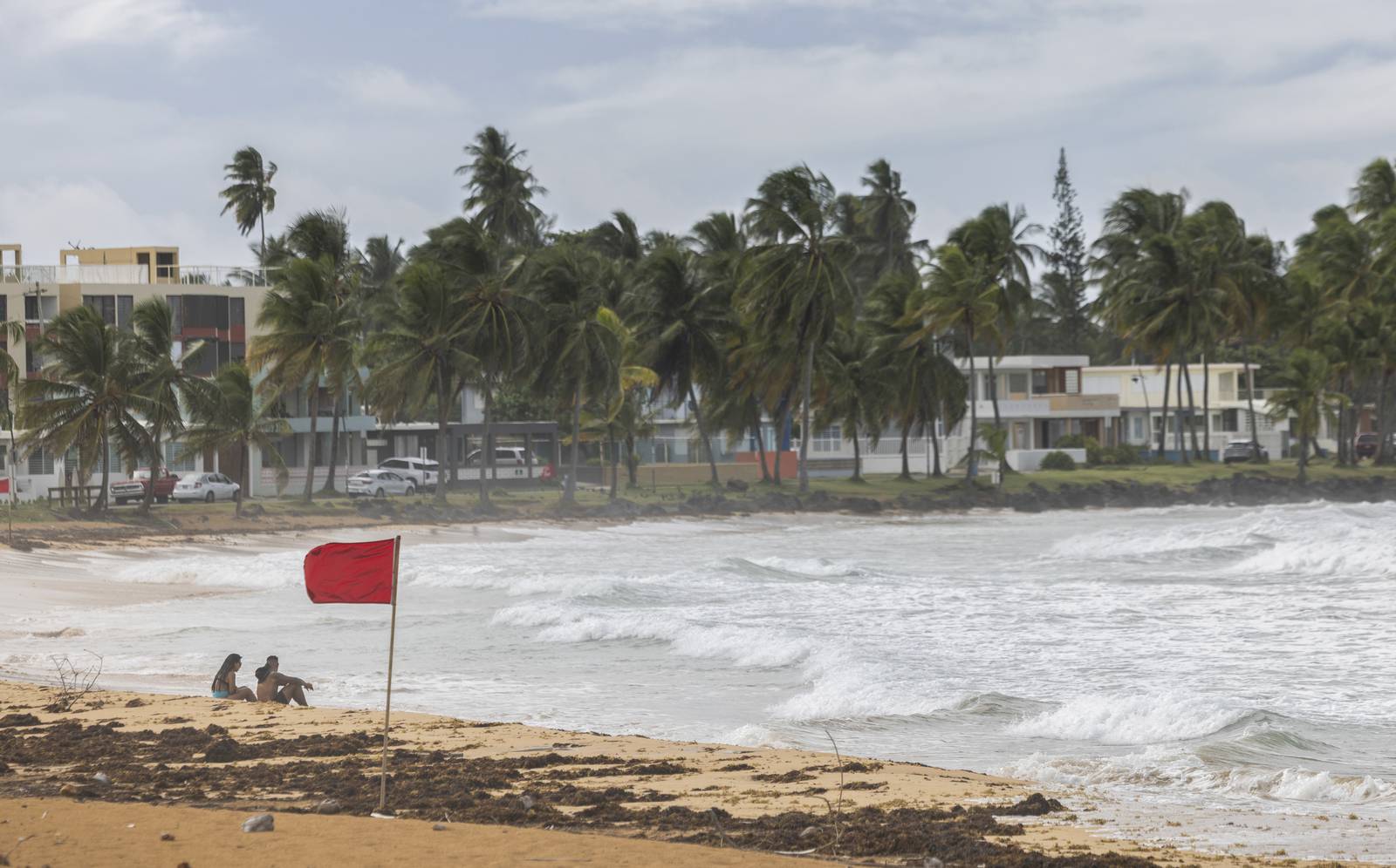 A strengthening Ernesto is poised to a hurricane after brushing