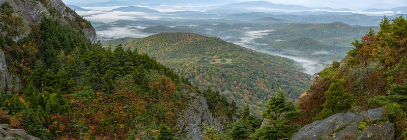 An early morning break in the clouds offers stunning views of color-dappled hills and valleys, as seen from atop Grandfather Mountain’s Linville Peak and the Mile High Swinging Bridge.