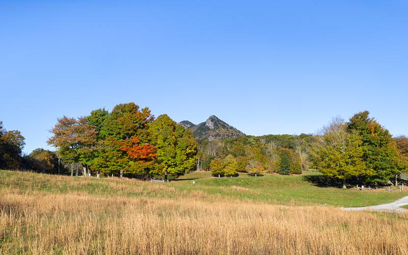 Grandfather Mountain’s color-dappled peaks rise beyond MacRae Meadows, site of the annual Grandfather Mountain Highland Games.