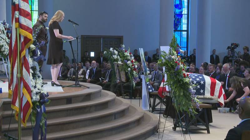 Ashley Ayer, wife of CMPD officer Joshua Eyer, speaks at the funeral.