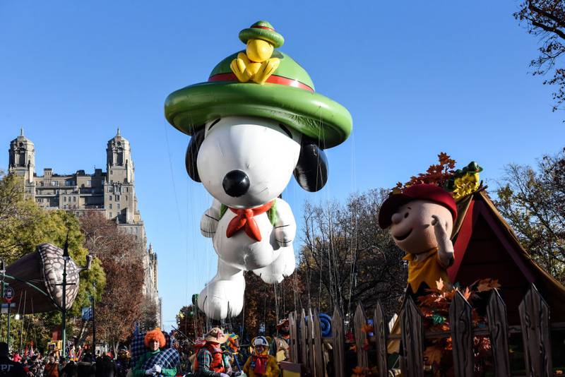 NEW YORK, NEW YORK - NOVEMBER 23: The Snoopy balloon floats in Macy's annual Thanksgiving Day Parade on November 23, 2023 in New York City. Thousands of people lined the streets to watch the 25 balloons and hundreds of performers march in this parade happening since 1924. (Photo by Stephanie Keith/Getty Images)