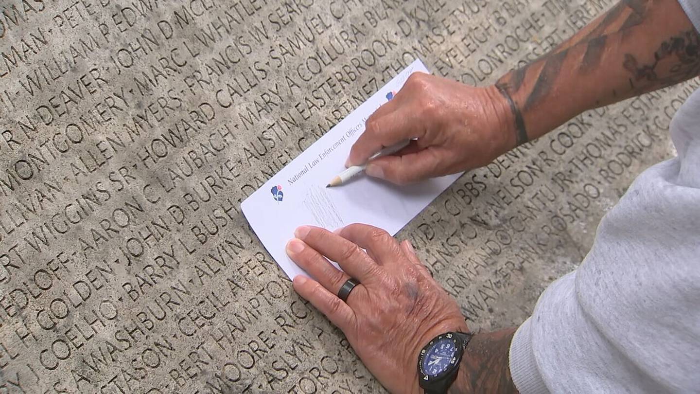 Tracing the names at the National Law Enforcement Officers Memorial wall