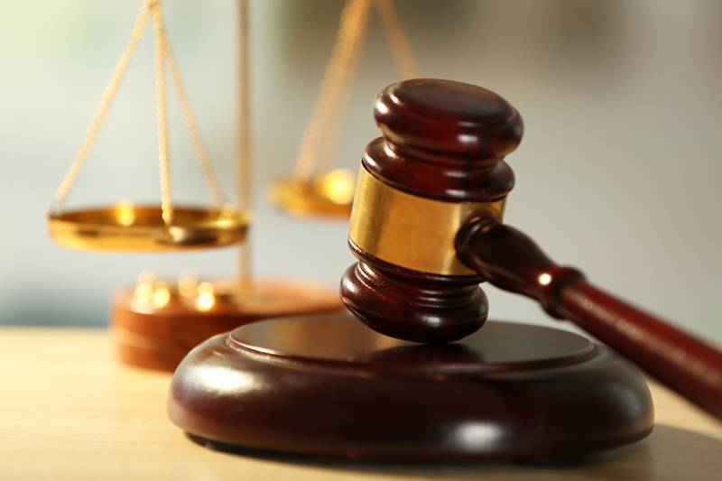 Wooden judges gavel on wooden table, close up