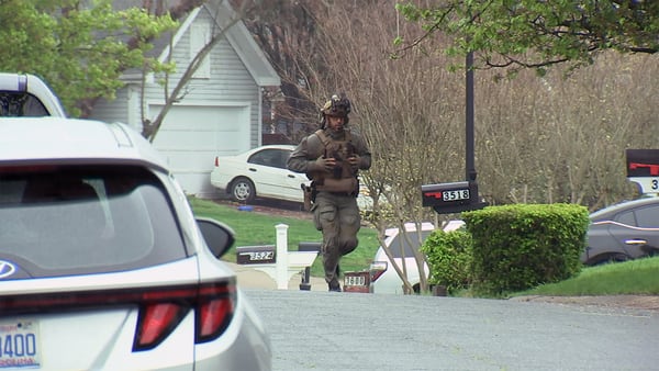 Homicide suspect in custody after hours-long standoff, police source says