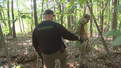 Law enforcement officers search woods near park in Alexander County