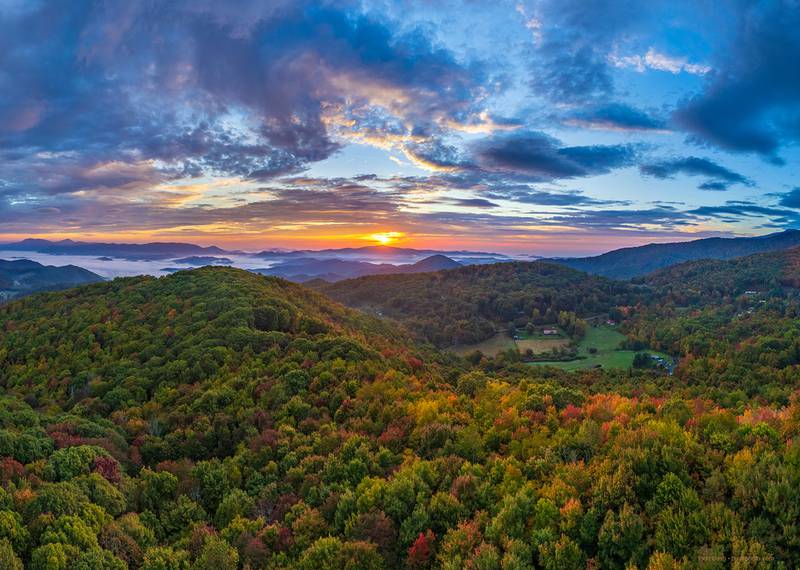 Sunrise cascades over the WNC High Country, highlighting bursts of fall color appearing in the area's lower elevations, as seen from the town of Banner Elk this past Sunday.