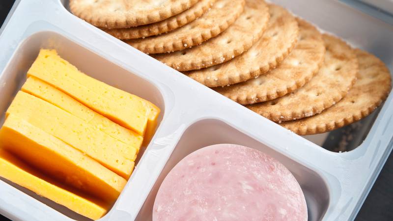 Meat, cheese and crackers in a plastic tray.