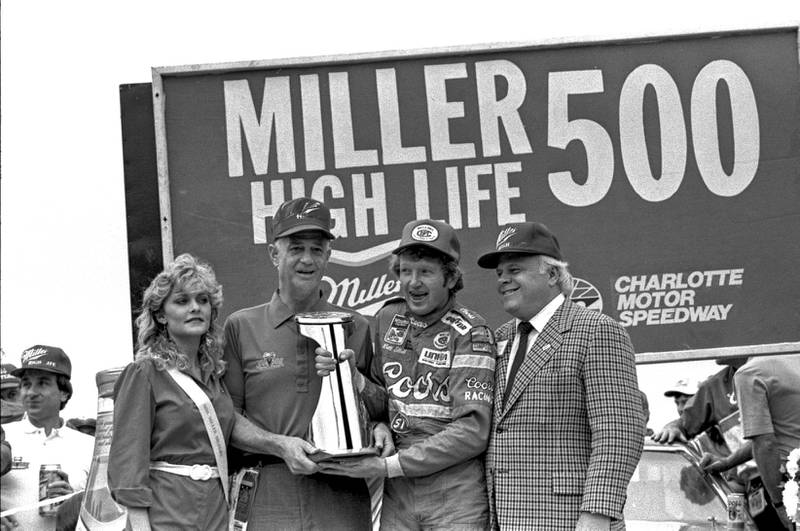Bill Elliott (2nd from right) and Bruton Smith (right) at the Miller High Life 500 in 1984.