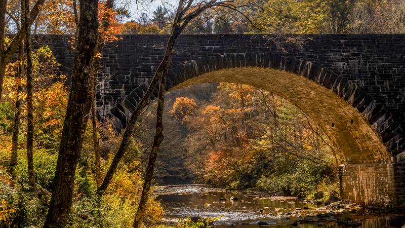 Oct. 26, 2022: Sunlight illuminates fall color and a Blue Ridge Parkway bridge near the Linville Falls Picnic Area, at Milepost 316.5, in this photo taken earlier this week. The drive along the Blue Ridge Parkway from the Linville Falls area to Spruce Pine is nice right now.
