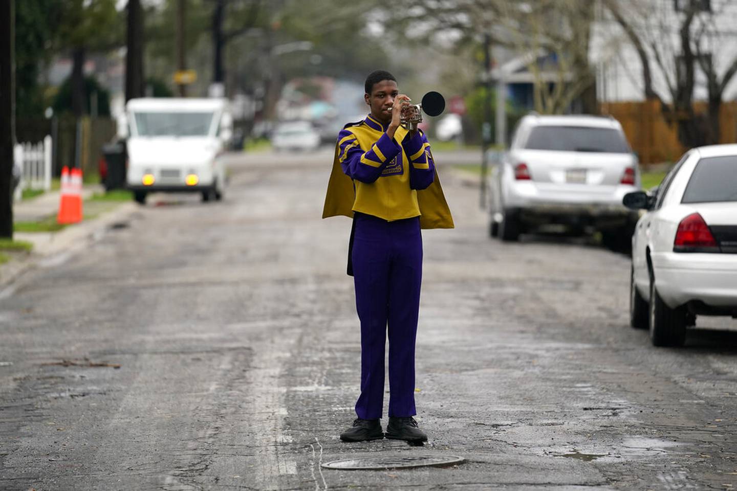 Elvin King III a senior at Warren Easton High and member of their marching band, which will not march because parades are cancelled, poses for a portrait in front of his home in New Orleans, Friday, Feb. 12, 2021. New Orleans' annual pre-Lenten Mardi Gras celebration is muted this year because of the coronavirus pandemic. Parades canceled. Bars closed. Crowds suppressed. Mardi Gras joy is muted this year in New Orleans as authorities seek to stifle the coronavirus's spread. And it's a blow to the tradition-bound city's party-loving soul.