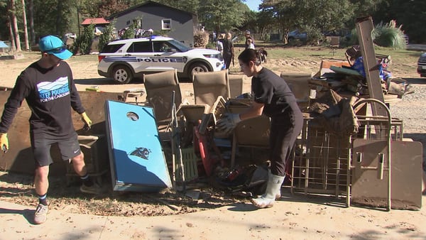 Volunteers with Panthers, Falcons help clean up Helene-ravaged neighborhood