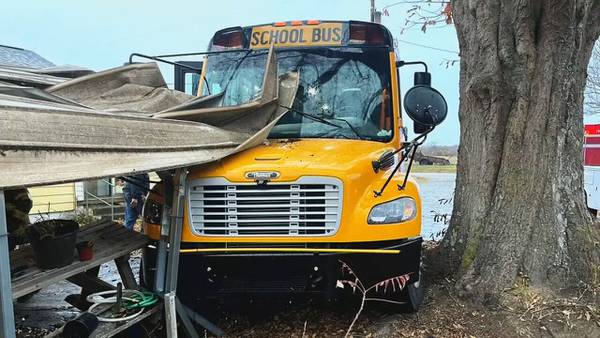 Student, driver taken to hospital after school bus crashes into carport, officials say