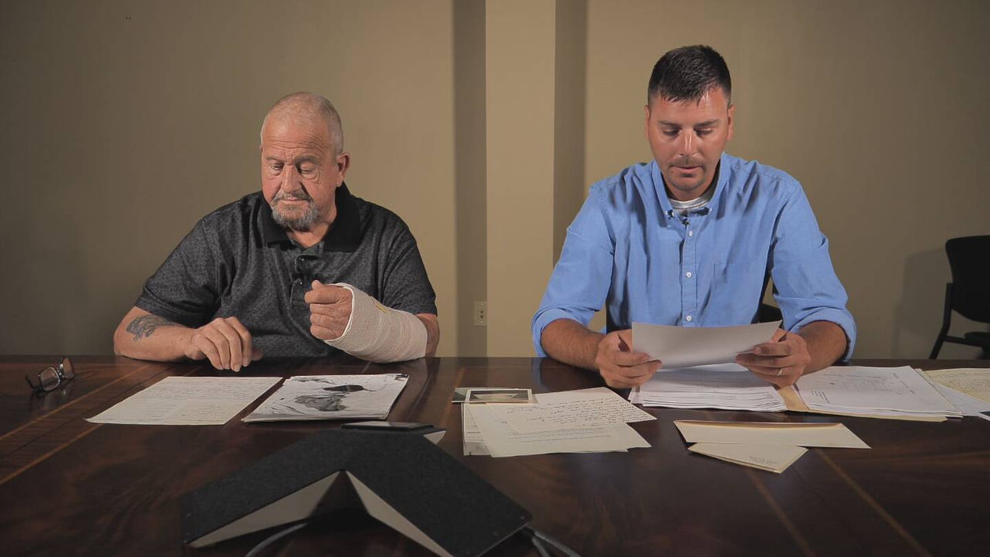 Gary Williams and Lt. Ryan Barkley look through case files