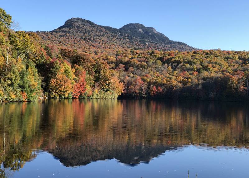 Fall color cascades down the lower slopes of Grandfather Mountain to the shores of nearby Grandfather Lake. This past weekend saw peak color throughout much of the WNC High Country, and experts anticipate elevations above 2,500 feet to follow suit this week.