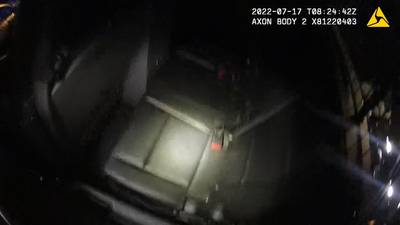 Body cam released after woman climbs out of moving police cruiser