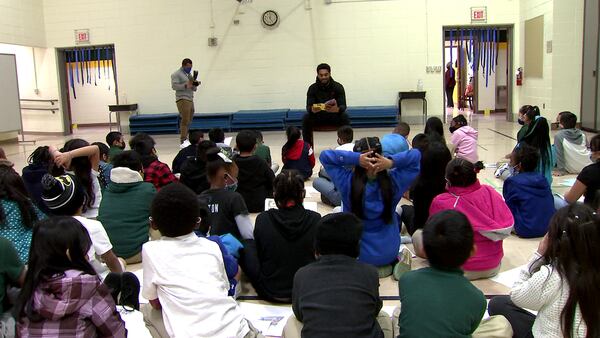 Carolina Panther spends day teaching financial literacy to students at Hidden Valley Elementary