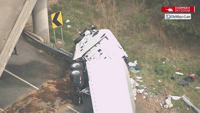 Photos: Tractor-trailer flips, spills fuel on ramp to I-77 in north Charlotte