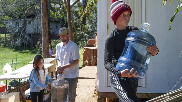 After hurricane, with no running water, residents organize to meet a basic need