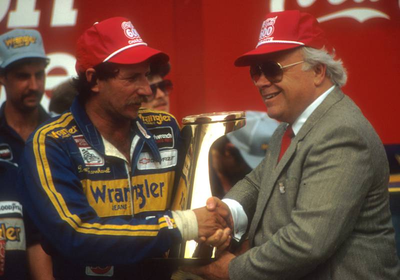 Dale Earnhardt receives congratulations from track owner Bruton Smith after winning the Coca-Cola 600 at the Charlotte Motor Speedway in May 1986.