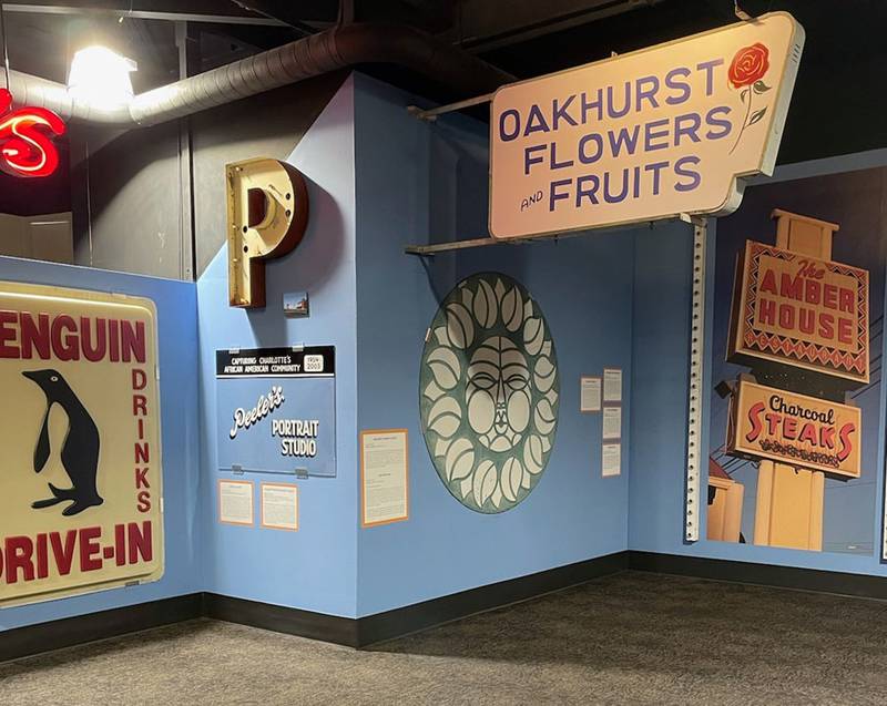A new exhibit at the Charlotte Museum of History features signs from neighborhoods across the city, including Dilworth, Oakhurst, Plaza Midwood, Uptown, and the museum’s own stomping grounds East Charlotte.