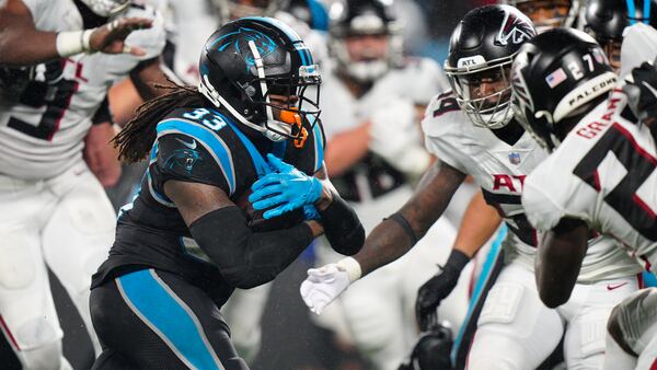 Foreman leads Panthers past rival Falcons in rain, 25-15 