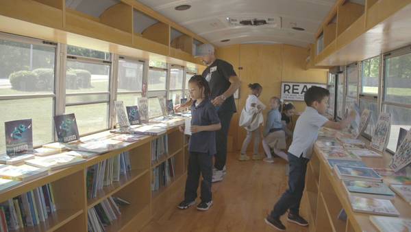 Hornets’ book bus inspires students to get pumped about reading