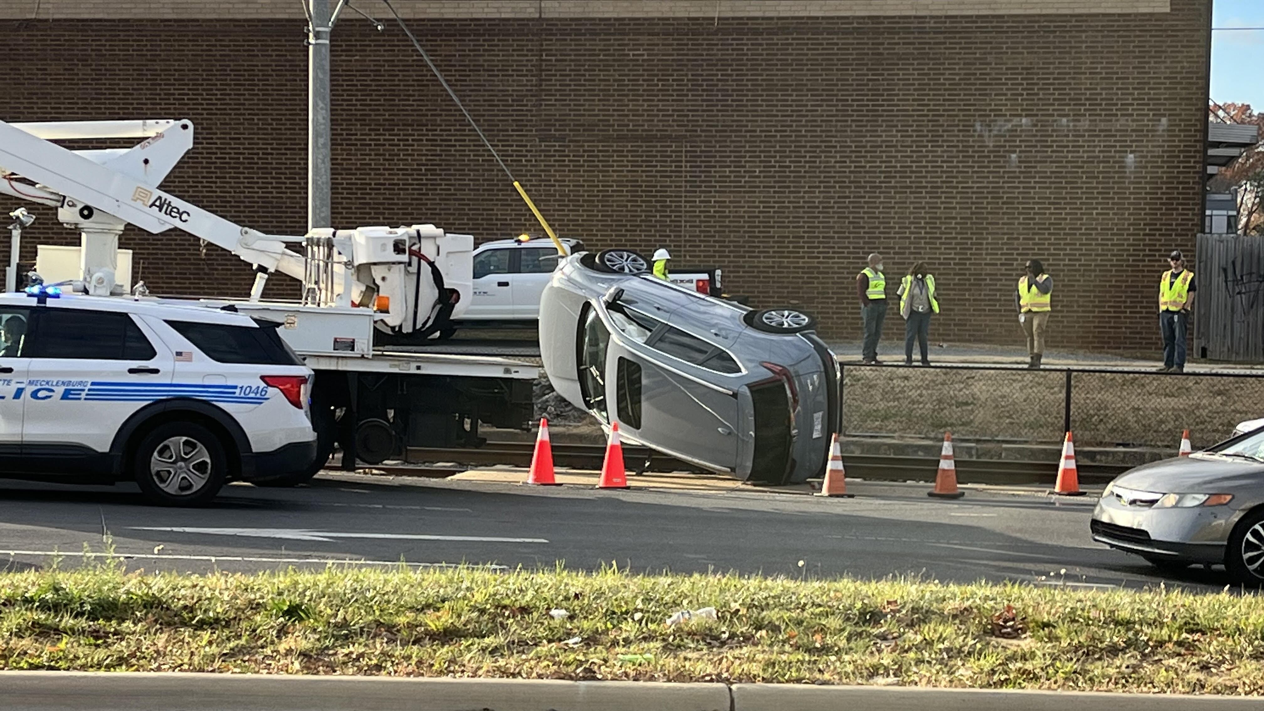 Car flips near light rail tracks in south Charlotte