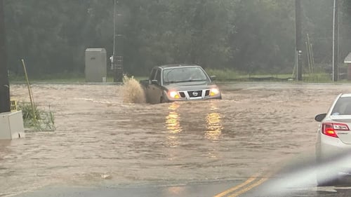 A truck drives through high water in Rock Hill on Aug. 8, 2024