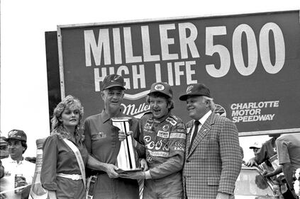 Bill Elliott (2nd from right) and Bruton Smith (right) at the Miller High Life 500 in 1984.