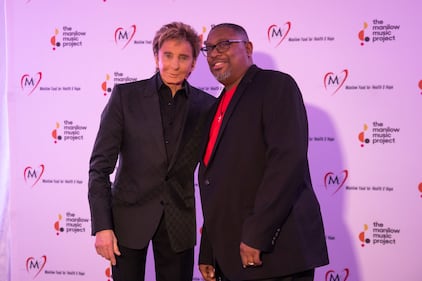 Singer Barry Manilow presents Walter Suggs of Phillip O Berry Academy of Technology High School with The Manilow Music Project Music Teacher Award in Charlotte.  Suggs received $5,000 cash and another $5,000 in “Manilow bucks” to purchase musical instruments for his school’s music program.