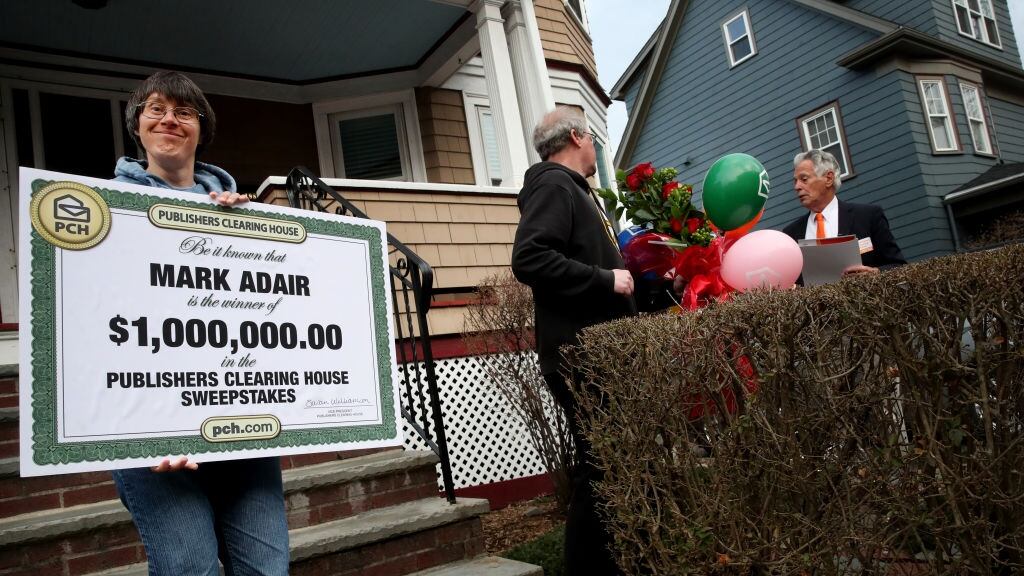 A person holding an oversized Publishers Clearing House check.