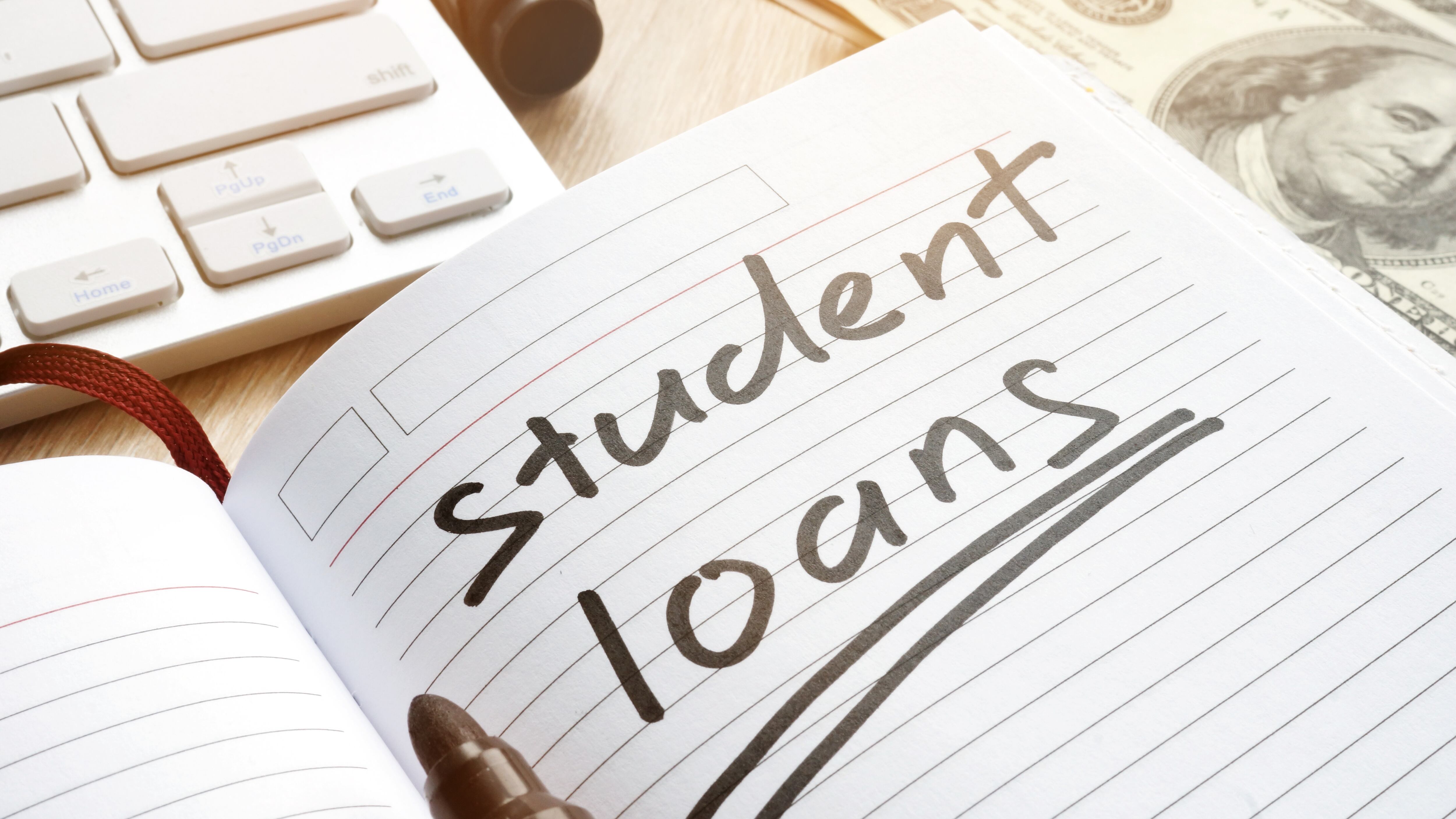 Student loan handwritten in a note. Money for education.