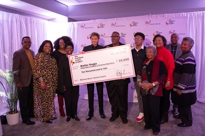 Singer Barry Manilow presents Walter Suggs of Phillip O Berry Academy of Technology High School with The Manilow Music Project Music Teacher Award in Charlotte.  Suggs received $5,000 cash and another $5,000 in “Manilow bucks” to purchase musical instruments for his school’s music program.