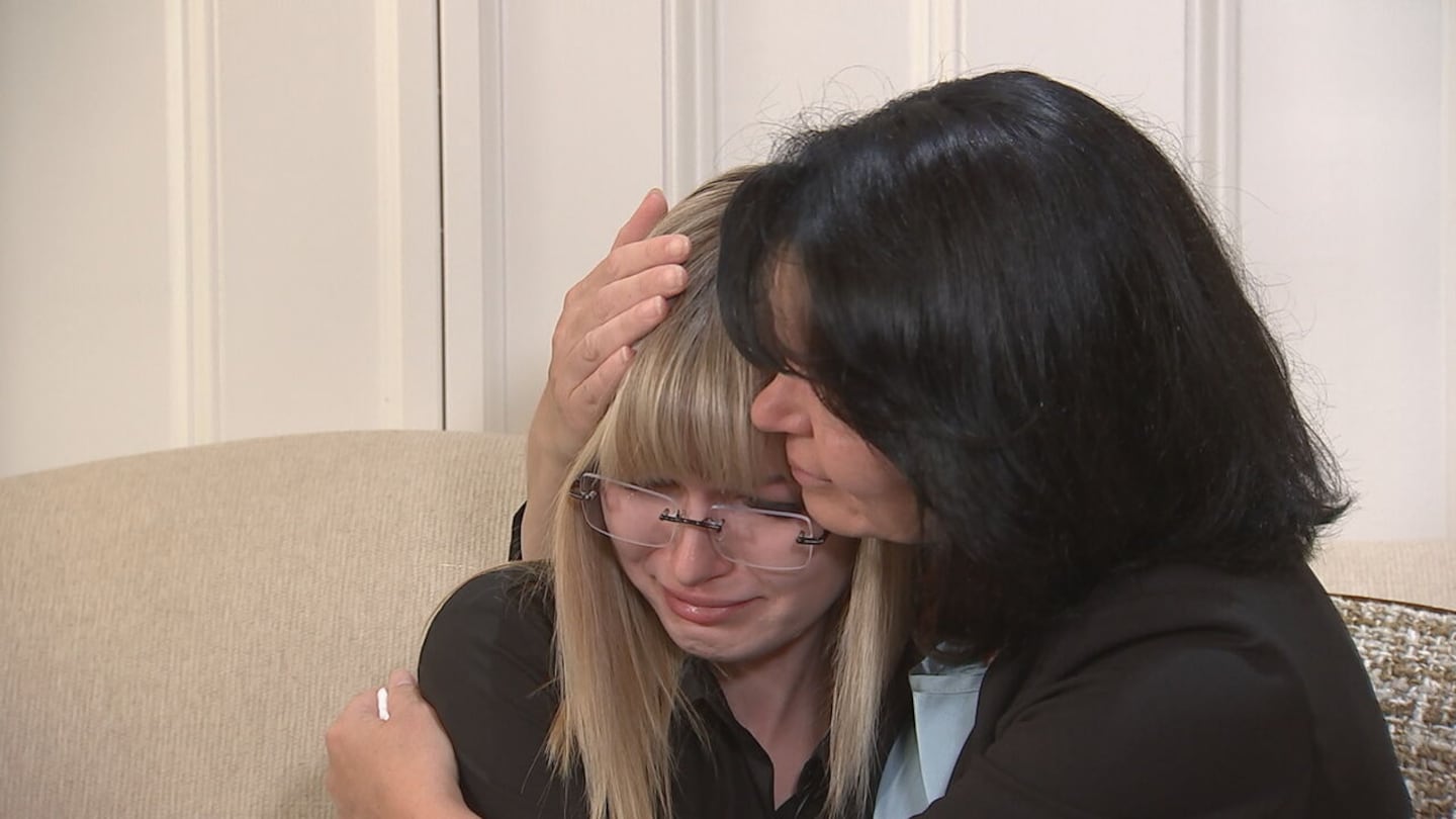 Iryna's sister, Valeria, is comforted by her mother, Anna