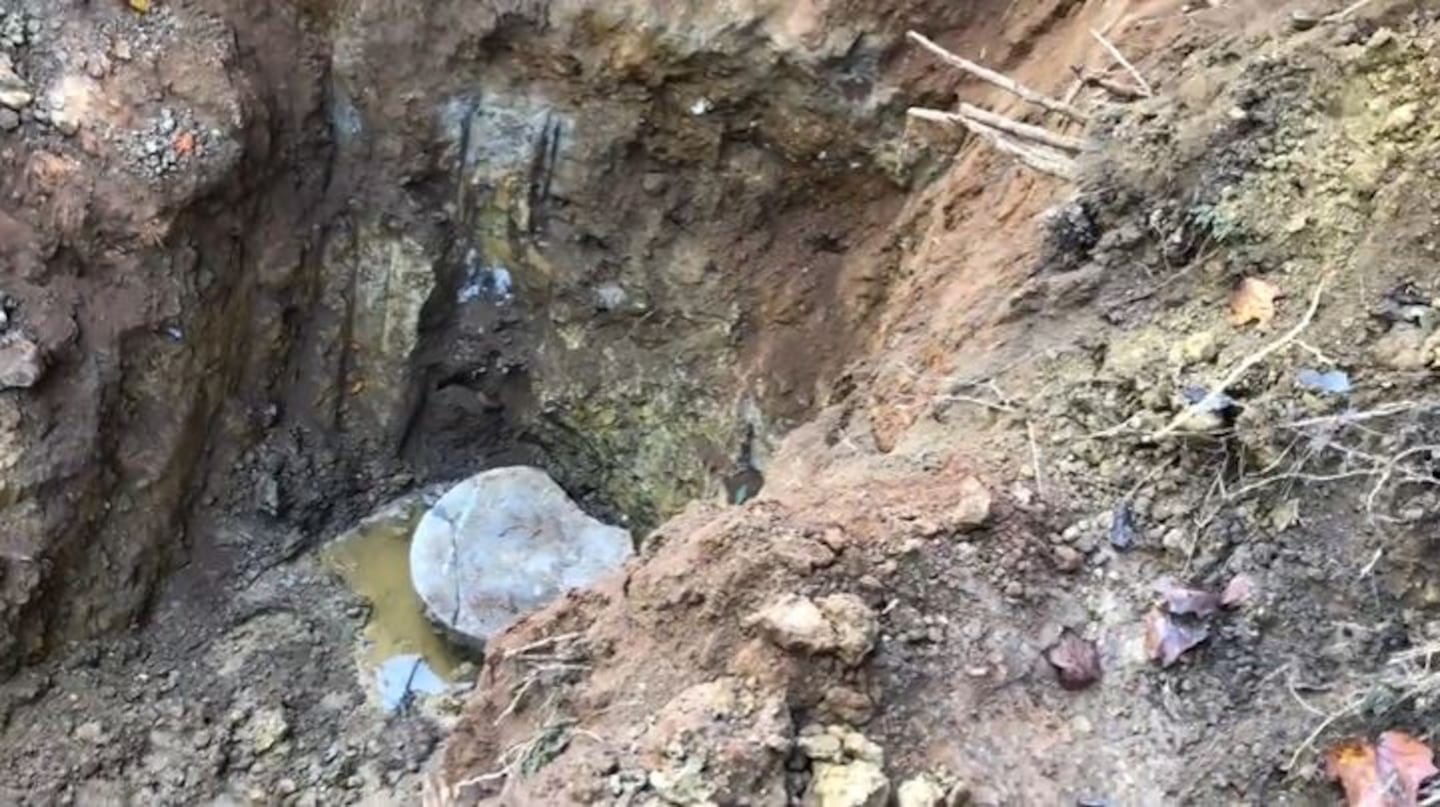 Investigators in Morganton say they found a body in a well and two people are charged with concealing a death.