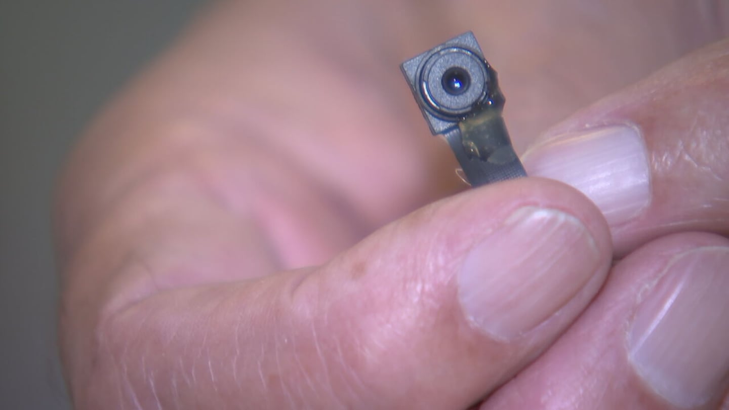 Skip Graham holds an example of a small hidden camera