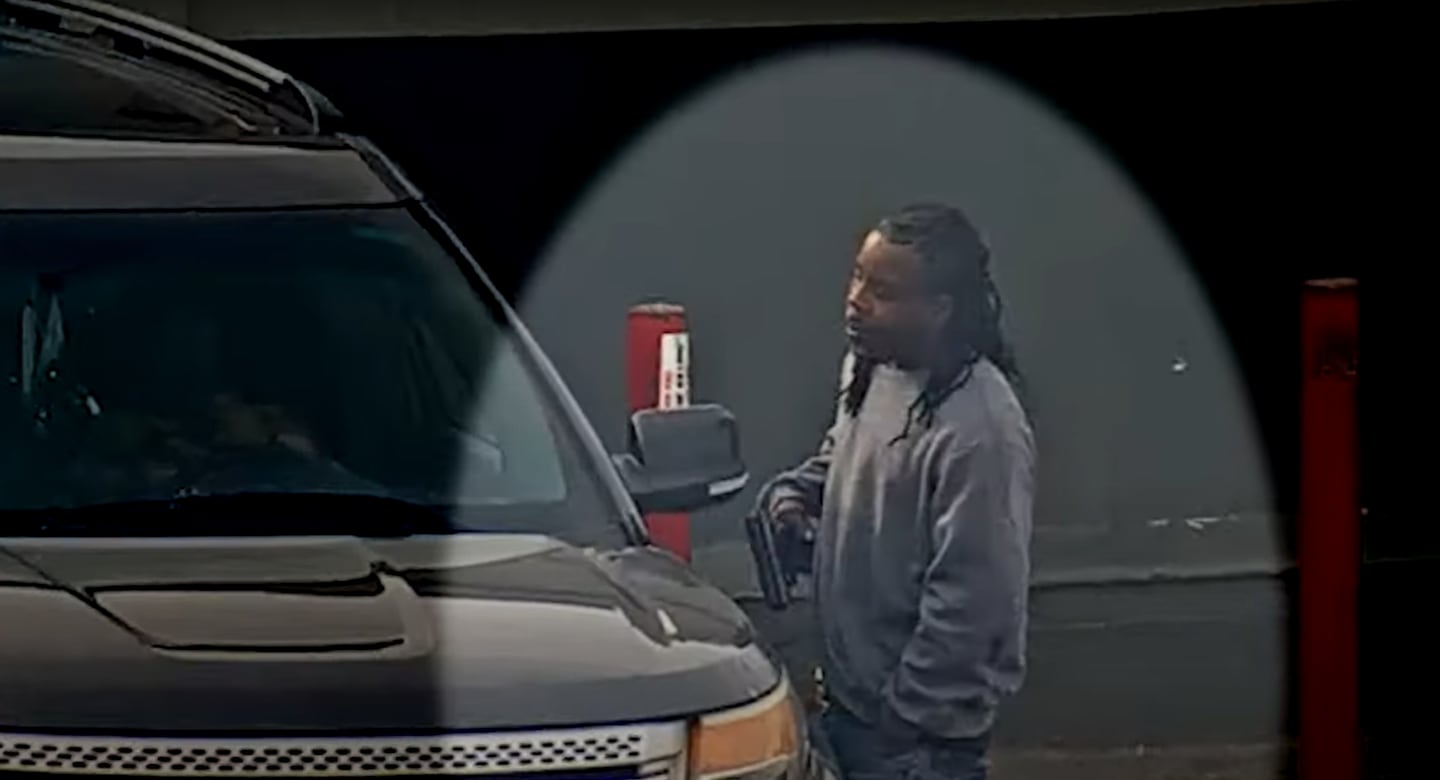 Tim Moore holding a gun on surveillance video