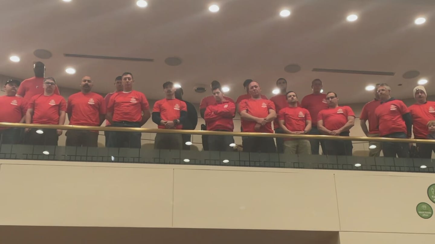 Firefighters line up at Monday night's city council meeting in Charlotte to call for better pay
