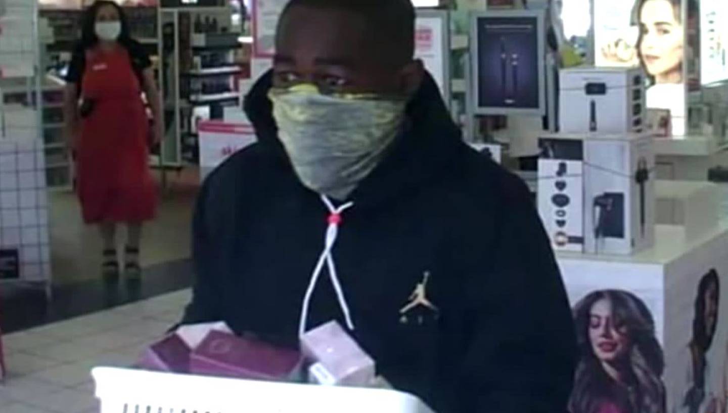 Surveillance image of a man stealing perfume from an Ulta store in Morganton, North Carolina.