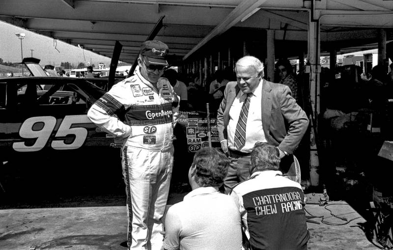 Benny Parsons (left), Bruton Smith (right) and David Pearson (seated, right) at the Miller High Life 500 in 1984.