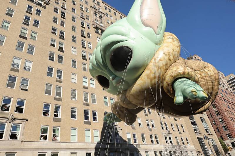 NEW YORK, NEW YORK - NOVEMBER 23: Funko Pop!-styled Grogu™ balloon heads down the parade route during the Macy's Thanksgiving Day Parade on November 23, 2023 in New York City. (Photo by Michael Loccisano/Getty Images)